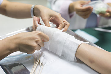 person having arm bandaged