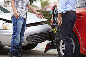 car accident with two men talking to each other beside it