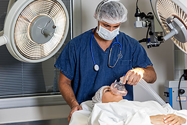 Filing-a-Medical-Malpractice-Case-in-Illinois Filing medical malpractice in Illinois photo of doctor with mask on putting mask on patient
