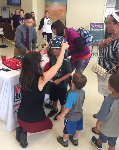 Children being fitted for helmets for hard headed kids program