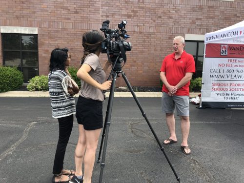 Dennis VanDerGinst speaking for TV Camera at program